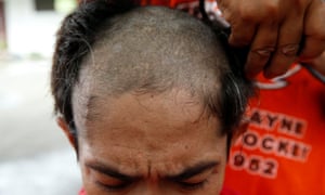 A newly-admitted drug user gets his head shaved