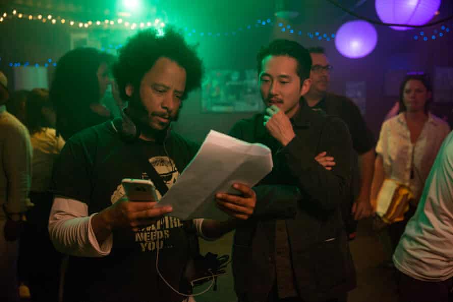 Boots Riley and Steven Yeun on the set of Sorry to Bother You.