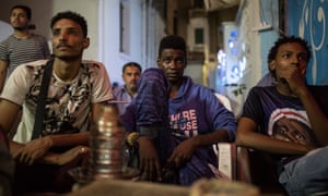 All eyes are focused on the TV screen in the Cairo coffee-house.