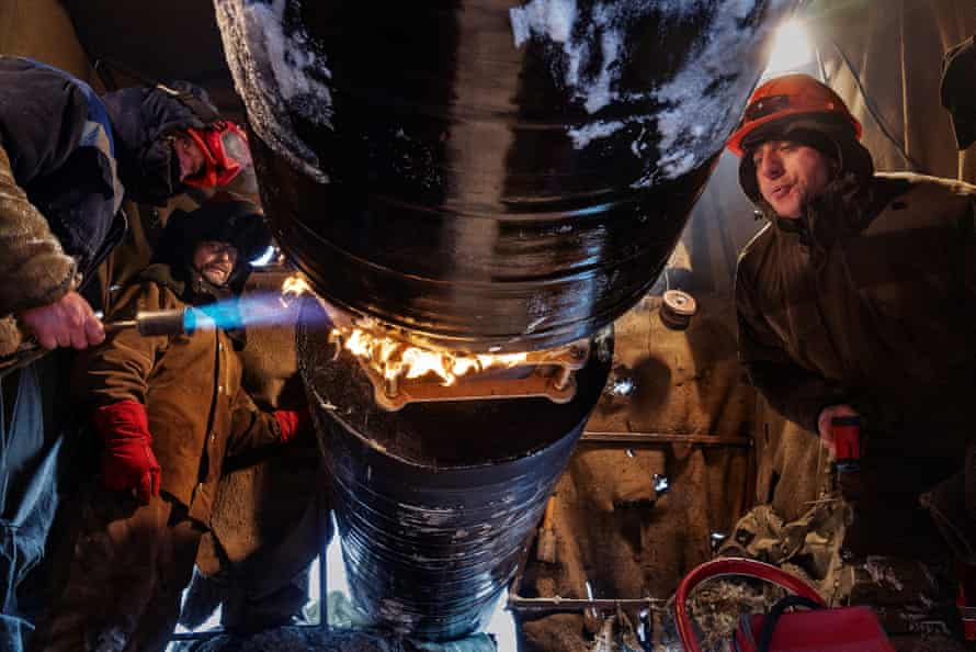 Workers connect a pipeline on top of the permafronst at a site in Novy Urengoy, a city built by Gazprom in 1980s in Siberia to extract Russia’s biggest gas field.