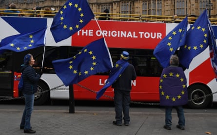 Anti-Brexit protesters wave EU flags outside parliament in London.