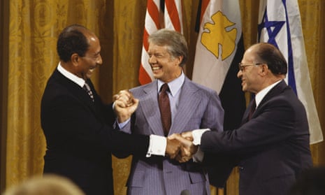 Egyptian president Anwar Sadat, US president Jimmy Carter and Israeli prime minister Menachem Begin join hands after the Camp David Accords in September 1978.