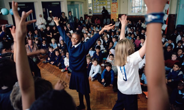 Pupils at Millfields community school in London perform an African dance during a school assembly as part of Black History Month. 