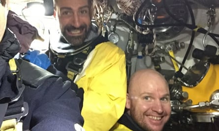 Chris Lemons and a colleage in the diving bell on board the Topaz, surrounded by equipment and wires.