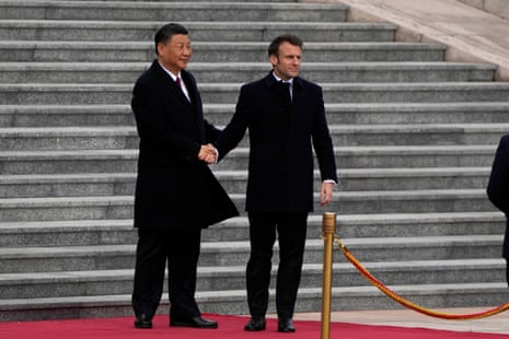 French President Emmanuel Macron shakes hands with Chinese President Xi Jinping during a welcome ceremony held outside the Great Hall of the People in Beijing.