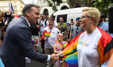 Pressman shakes hands with someone at Pride