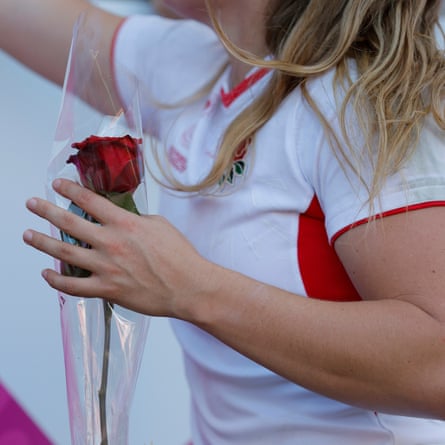 Jess Breach holds a single red rose given to her after the semi-final victory over France.