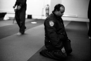 An NYPD traffic officer at prayer, in Manhattan, New York. All Photographs: Robert Gerhardt