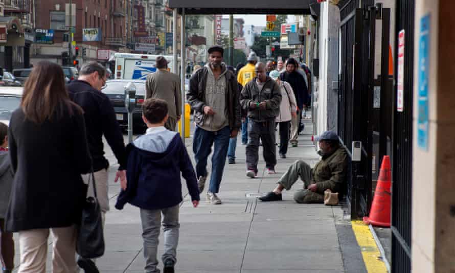 Pedestrians walk along Ellis Street in the Tenderloin district of San Francisco.