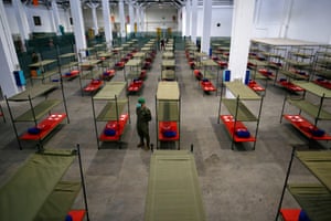 Barcelona, Spain: a soldier stands next to beds in a temporary hospital for vulnerable people