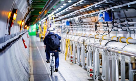 A man rides his bicycle along the beam line of the Large Hadron Collider.