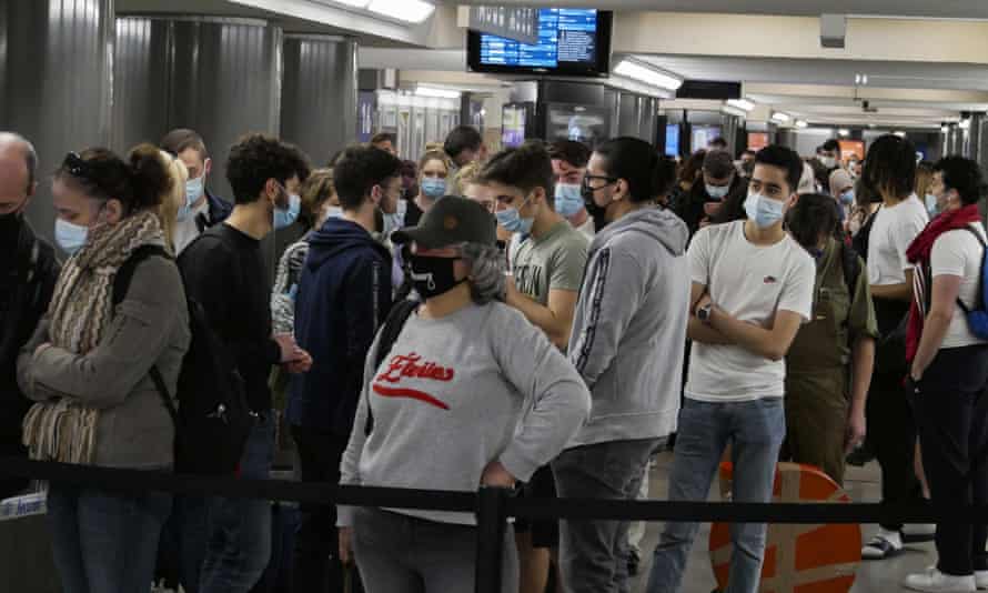 People wait to board a train heading to the coast at Brussels-Midi station