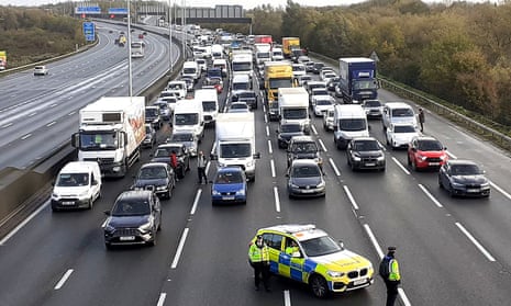 Police stopping traffic on the M25 where a Just Stop Oil protest was taking place on 8 November.