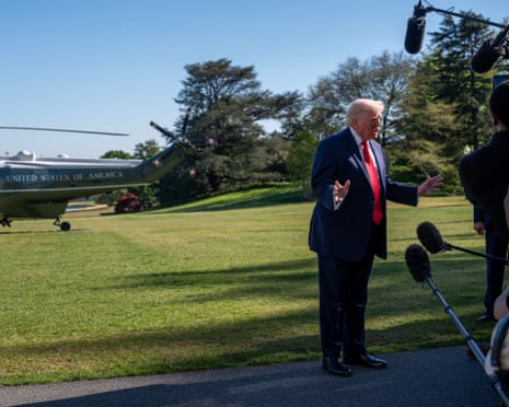 Donald Trump talks to reporters on the White House south lawn before boarding a US helicopter at the weekend