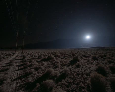 A bright glowing light hovers over a desert plain at night, demonstrating a rescue lighting technology