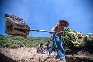 Gravediggers work digging several graves at the same time due to high demand during the pandemic at the San Miguel Xico cemetery in Valle de Chalco.