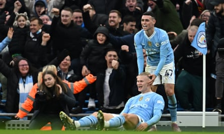 Erling Haaland (bottom) celebrates Phil Foden during the Premier League match between Manchester City and Manchester United at the Etihad Stadium on 3 March 2024