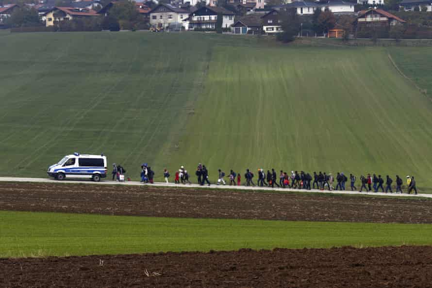 German police escort immigrants who have crossed from Austria to a registration centre, 2015.