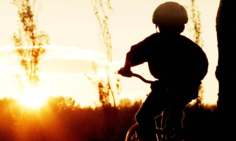 Silhouette of boy on bike