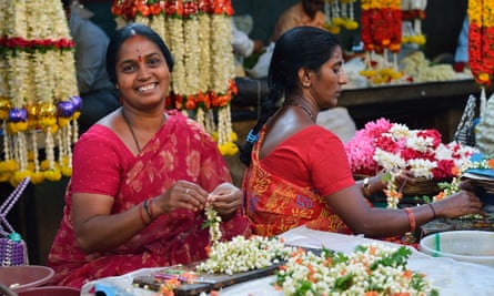 Workers at a flower stall in Devaraja market, Mysuru, India.