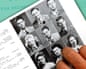A hand points at a grid of black-and-white yearbook reunion portrait photos beside a page of names