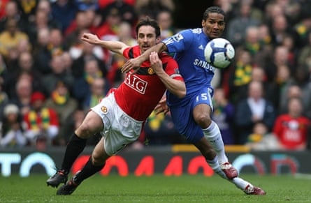 Gary Neville (left) battles for the ball with Florent Malouda