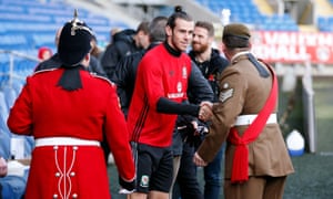 Cardiff, Wales Gareth Bale shakes hands with a member of the armed forces as part of remembrance commemorations before training