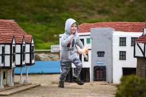 Boy runs past tiny houses