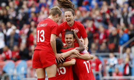 Canada captain Christine Sinclair, is mobbed by her teammates after scoring against Mexico in Toronto