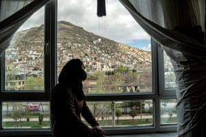 Tarawat, a 17-year-old girl who has stopped studying, looks out from a window in her room in Kabul