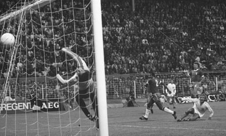Johan Neeskens gets in front of Luís Pereira (no 2) and strikes the ball over goalkeeper Émerson Leão to open the scoring in Netherland’s 2-0 victory over Brazil at the 1974 World Cup.