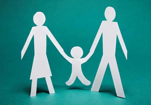 paper cut-outs of a man and a woman with a child