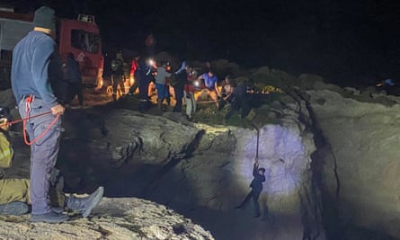 An Afghan refugee is pulled up ona rope during a rescue operation after the shipwreck.