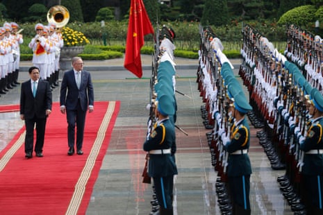 Vietnamese Prime Minister Pham Minh Chinh (L) and his Australian counterpart Anthony Albanese (2-L) review the guard of honor at the Presidential Palace in Hanoi.
