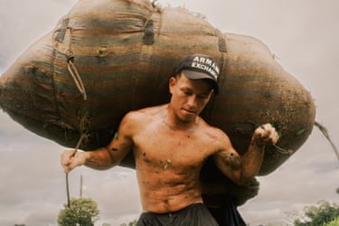 Daniel carries a huge sack of coca leaves on his back