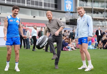 The Duke of Sussex kicks a ball during a session with the Western Bulldogs Australian rules football club in Footscray, Melbourne