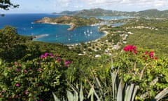 Nelson’s Dockyard and English Harbour in Antigua, with azure sea beyond, seen in the distance from Shirley Heights in Antigua