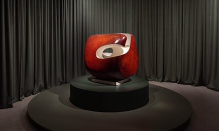 Roughly ball-shaped curved piece of wood, dark red on the outside and almost white on the inside