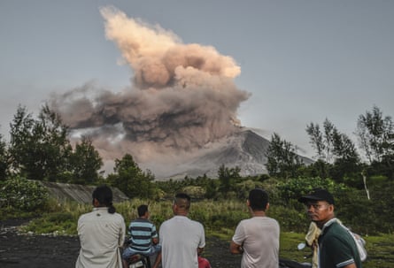 Residents look on as Mount Mayon erupts
