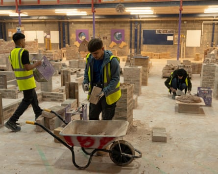 Students practising building walls at South and City College in Birmingham
