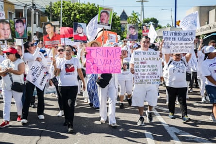 People in white shirts march with signs