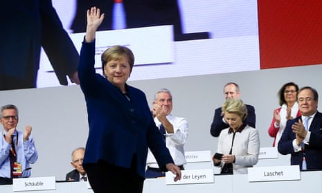 Angela Merkel waves at delegates after her speech at the Christian Democratic Union conference in Hamburg on Friday.