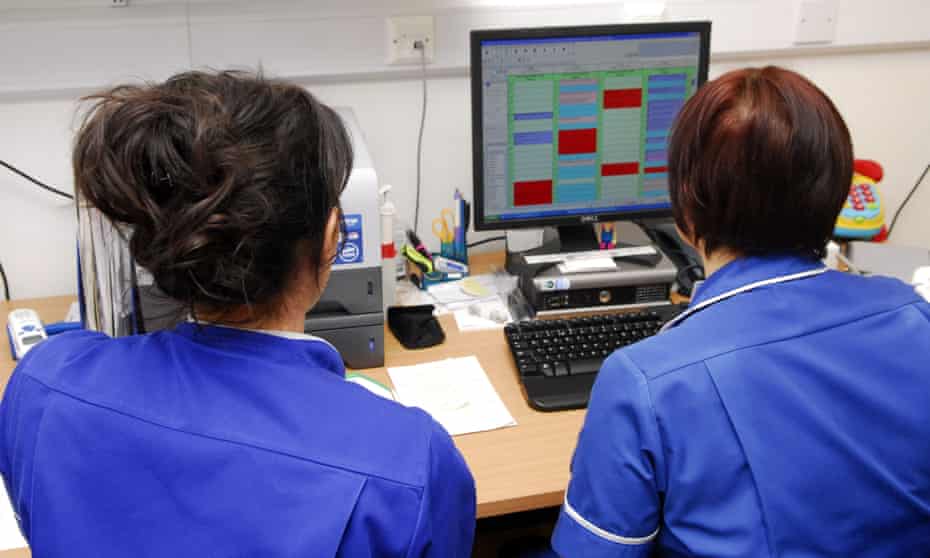 Two nurses working at a computer
