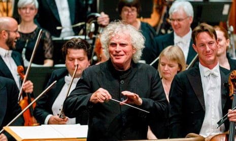 Sir Simon Rattle conducting the London Symphony Orchestra at the Barbican in London.