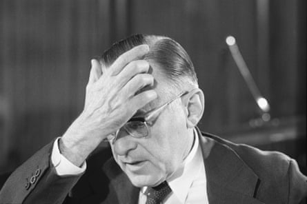 black and white picture of a man with his hand on his forehead