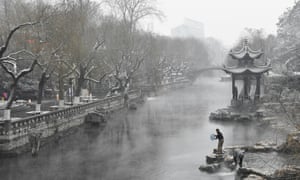 <strong>Jinan, China </strong><br>A man takes water from a moat as snow turns the city into a winter wonderland.