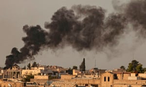 Smoke billows following Turkish bombardment on Syria’s northeastern town of Ras al-Ain.