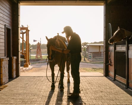 pair in front of large door with light shining in