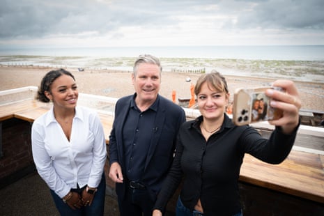 Keir Starmer posing for a selfie with two women on the seafront