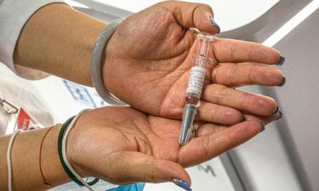 A staff member shows a coronavirus vaccine candidate at Sinovac Biotech Ltd stand at the 2020 China International Fair for Trade in Services in Beijing, China on 13 September 2020. 
